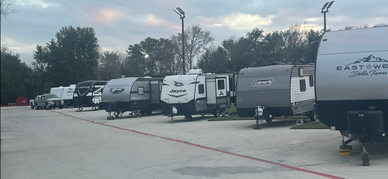Paved RV spaces arranged in a clean row during the day