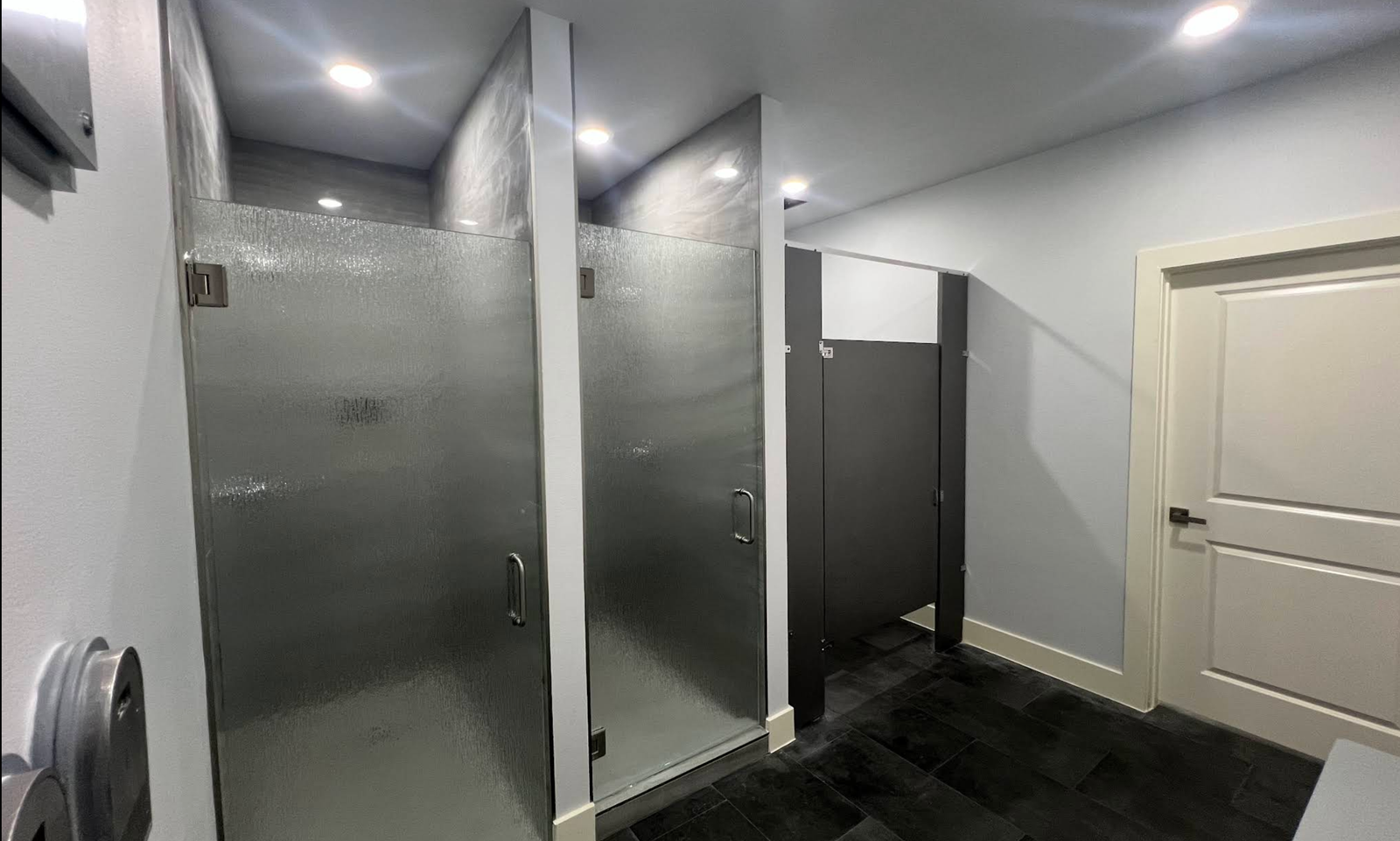 Row of modern private shower stalls